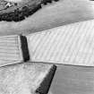 Oblique aerial view centred on the cropmarks of the settlement and enclosure, taken from the ENE.