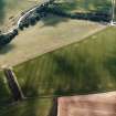 Oblique aerial view centred on the crop marks of the settlement, with the crop marks of the enclosure and rig adjacent, taken from the ENE.