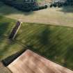 Oblique aerial view centred on the crop marks of the settlement, with the crop marks of the enclosure and rig adjacent, taken from the NE.