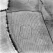Grizzlefield, East and West Rings, oblique aerial view, taken from the WNW, centred on the cropmarks of two forts.