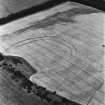 Birkenside Hill, oblique aerial view, taken from the SW, centred on the cropmarks of a fort, enclosures and linear cropmarks.