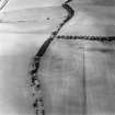 Oblique aerial view centred on the soilmarks of the fort, taken from the SSE.