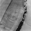 Oblique aerial view centred on the soilmarks of the fort, taken from the NNW.