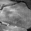 Oblique aerial view of West Morriston centred on the cropmarks of a fort, taken from the NNW.