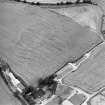 Oblique aerial view of West Morriston centred on the cropmarks of a fort, taken from the NW.