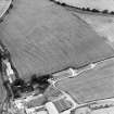 Oblique aerial view of West Morriston centred on the cropmarks of a fort, taken from the N.
