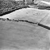 Oblique aerial view centred on the parchmarks of the fort, taken from the ENE.