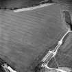 Oblique aerial view of West Morriston centred on the cropmarks of a fort, taken from the NE.