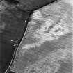 Congalton, oblique aerial view, taken from the NE, centred on cropmarks including a pit-alignment, possible enclosure, ring-ditch and indeterminate marks. A settlement is visible in the top half of the photograph.