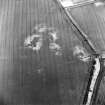 Oblique aerial view centred on the cropmarks of the settlement, pit-alignment, unenclosed settlement and cropmarks, taken from the W.