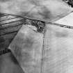 Oblique aerial view centred on the cropmarks of the palisaded settlement, taken from the W.