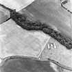 Athelstaneford Mains, oblique aerial view, taken from the SE, centred on the cropmarks of an enclosure.