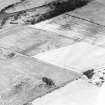 Oblique aerial view centred on the cropmarks of the pit-alignments with fort adjacent, taken from the SSW.