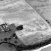 Oblique aerial view centred on the burial-ground, watermill, farmhouse and farmsteading, and the cropmarks of the nunnery, taken from the S.