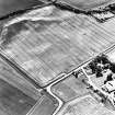 Preston Mains, oblique aerial view, taken from the N, centred on the cropmarks of a possible cursus monument and enclosure.