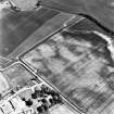 Preston Mains, oblique aerial view, taken from the NW, centred on the cropmarks of a possible cursus monument and enclosure. A linear cropmark is visible in the bottom right-hand corner of the photograph.