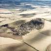 Oblique aerial view centred on the remains of the fort showing recent fire damage, taken from the SSW.