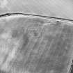 Oblique aerial view centred on the cropmarks of the settlement, taken from the NNE.