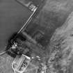 Whitelaw, oblique aerial view, taken from the SSW, centred on the cropmarks of an enclosure adjacent to a farmhouse and farmsteading.