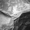 Oblique aerial view centred on the remains of the farmstead, taken from the SW.