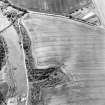 Oblique aerial view of Easter Broomhouse centred on the cropmark of a fort.  Taken from the NE.