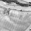 Oblique aerial view of Easter Broomhouse centred on the cropmark of a fort.  Taken from the NW.