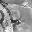 Oblique aerial view centred on the cropmarks of the fort and linear cropmarks with waterworks adjacent, taken from the E.