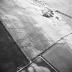 Doon Hill, oblique aerial view, taken from the ESE, centred on the cropmarks of a possible settlement and round houses.