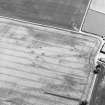Oblique aerial view of Wester Broomhouse centred on the cropmark of a possible trackway, with the cropmark of a possible pit-alignment adjacent.  Taken from the NW.