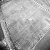 Oblique aerial view centred on the cropmarks of the possible trackway and further cropmarks with linear cropmark adjacent, taken from the E.