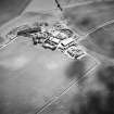 Oblique aerial view centred on the cropmarks of the settlements and cropmarks with the cropmarks of the settlement adjacent, taken from the NNE.