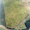 Oblique aerial view centred on the cropmarks of the fort, field boundaries and cropmarks, taken from the NW.