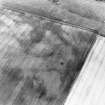 Oblique aerial view centred on the cropmarks of the linear cropmarks, pits and possible roundhouse, taken from the SE.