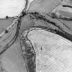 Oblique aerial view centred on the cropmarks of the fort, taken from the W.