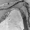 Oblique aerial view centred on the cropmarks of the fort, taken from the SW.