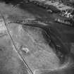 Oblique aerial view centred on forts from SW.