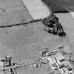 Oblique aerial view of Redden centred on the remains of a grange with a farmsteading adjacent, taken from the NE