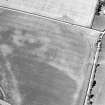 Oblique aerial view centred on the cropmarks of the enclosure, taken from the SE.