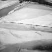 Oblique aerial view centred on the cropmarks of the settlement, the possible fort and possible causewayed enclosure, taken from the SE.