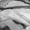 Oblique aerial view centred on the cropmarks of the settlement, the possible fort and possible causewayed enclosure, taken from the E.