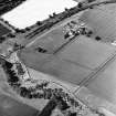 Oblique aerial view centred on the cropmarks with the farmhouse and steading adjacent, taken from the S