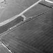 Skateraw, oblique aerial view, taken from the W, centred on cropmarks including an enclosure and ring-ditch. Further cropmarks are visible in the top left-hand corner of the photograph.