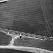 Skateraw, oblique aerial view, taken from the NNE, centred on cropmarks including an enclosure and ring-ditch.