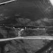 Skateraw, oblique aerial view, taken from the NE, centred on the cropmarks of an enclosure, and an area with ring-ditches, a pit-circle and possible cists is visible in the bottom half of the photograph. Reinforced flasks from the Torness Powerstation being loaded are shown in the centre of the photograph.