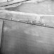 Skateraw, oblique aerial view, taken from the SSW, centred on cropmarks, including those of an enclosure.