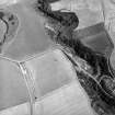 Oblique aerial view centred on the cropmarks of the settlement and rig, taken from the W.