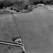 Oblique aerial view of Thornton Law centred on the cropmark of an enclosure.  Taken from the NE.