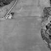 Oblique aerial view of Thornton Law centred on the cropmark of an enclosure.  Taken from the WNW.