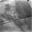 Oblique aerial view centred on the cropmarks of the fort, taken from the W.