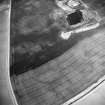 Oblique aerial view centred on the cropmarks of the settlement with settlement adjacent, taken from the SSE.